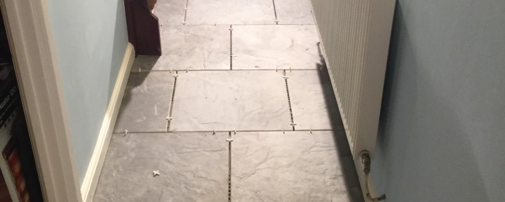 Hallway Tiling with riven stone effect tiles.